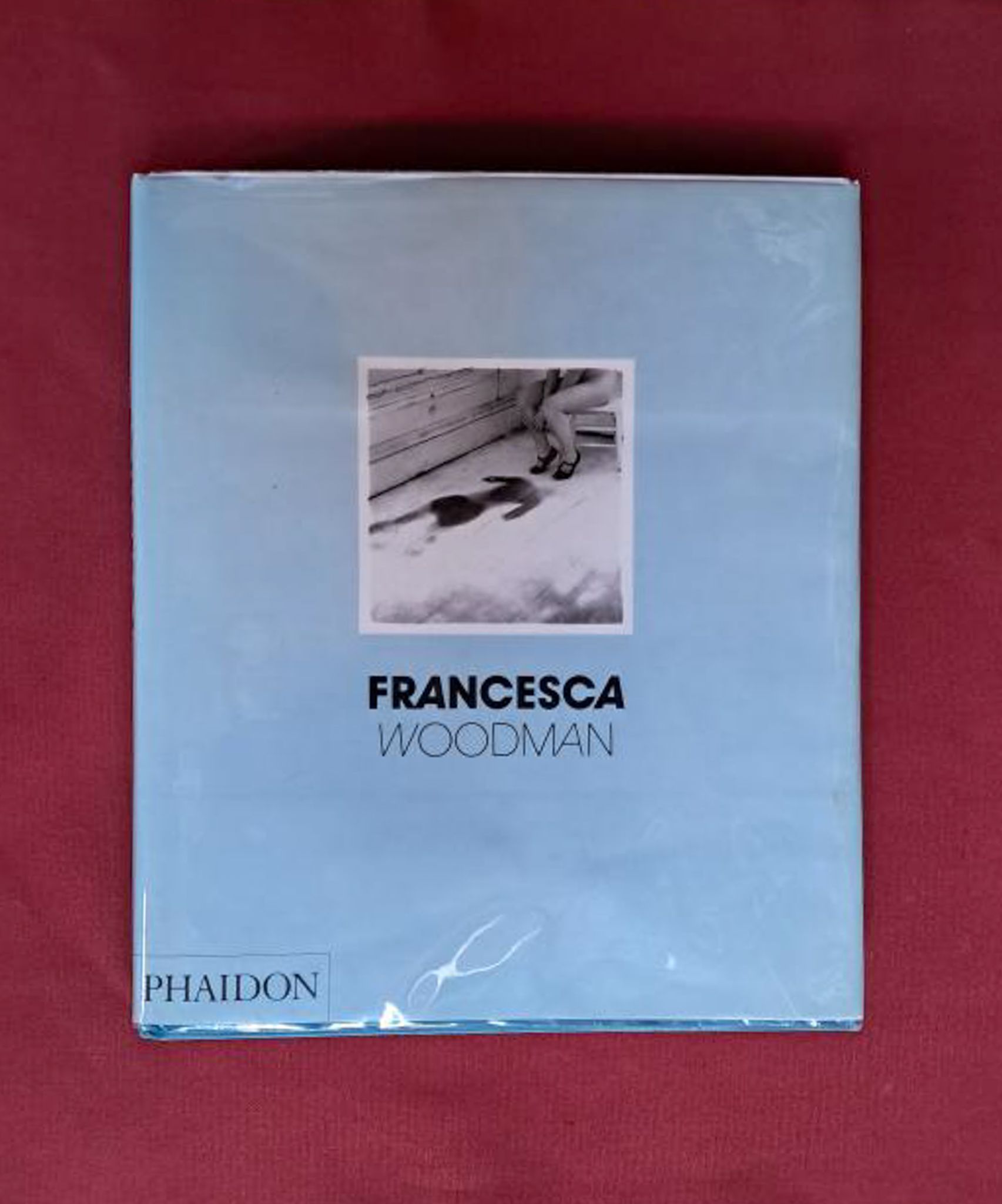 Francesca Woodman. Pale blue book cover set on a dark red backgrond