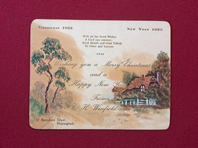 Christmas greeting card from 1923 with a house and trees on the front