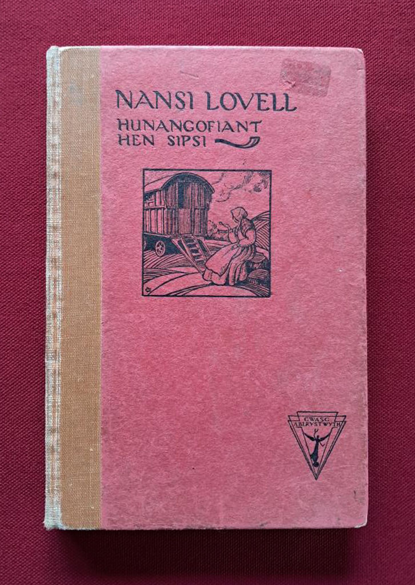 Nansi Lovell. Light red book on a dark red background